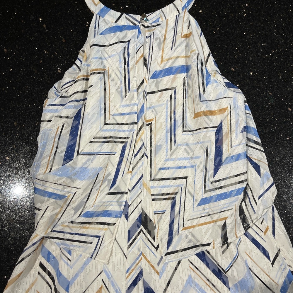 Beautiful, sleeveless, high neck layered top.